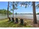 Lake views from the backyard with four chairs available for relaxing by the water at 112 Nautilus Ct, Troutman, NC 28166