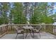 Intimate deck setting with table and chairs, perfect for enjoying the peaceful surroundings at 112 Nautilus Ct, Troutman, NC 28166