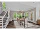Bright dining room with hardwood floors, large windows, rustic table, and decorative lighting fixture at 112 Nautilus Ct, Troutman, NC 28166