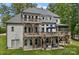 Beautiful exterior with multi-level deck overlooking a well-maintained lawn and mature trees at 112 Nautilus Ct, Troutman, NC 28166