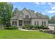 Beautiful two-story home featuring a manicured lawn, stone accents, and a welcoming front entrance at 112 Nautilus Ct, Troutman, NC 28166