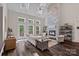 Elegant living room with a vaulted ceiling, fireplace, and access to an outdoor deck at 112 Nautilus Ct, Troutman, NC 28166