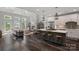 Bright living room with a fireplace, skylights, and an open view to the kitchen and deck at 112 Nautilus Ct, Troutman, NC 28166