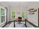 Bright office space with large windows, a modern desk, and custom shelving at 112 Nautilus Ct, Troutman, NC 28166