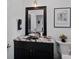 Stylish powder room with a vessel sink, granite countertop, and decorative mirror at 112 Nautilus Ct, Troutman, NC 28166