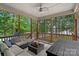 Screened porch with comfortable seating and great view of the lake and back yard at 112 Nautilus Ct, Troutman, NC 28166