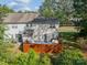 Aerial view of a fenced backyard featuring a patio, artificial grass, and a grill, creating an inviting outdoor space at 11515 Retriever Way, Charlotte, NC 28269