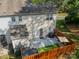 Aerial view of a private fenced backyard with a patio, artificial grass, and a grill, perfect for outdoor enjoyment at 11515 Retriever Way, Charlotte, NC 28269