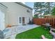 Charming backyard features a cozy patio, artificial grass, and a privacy fence, ideal for outdoor entertaining at 11515 Retriever Way, Charlotte, NC 28269