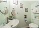 This half-bathroom features modern fixtures, cute art, and a decorative round mirror at 11515 Retriever Way, Charlotte, NC 28269