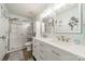 Well-lit bathroom boasts double sinks, a shower, wood-look flooring, and white cabinets at 11515 Retriever Way, Charlotte, NC 28269