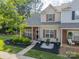 Charming townhome with a brick facade, tasteful landscaping and a sidewalk leading to the front door at 11515 Retriever Way, Charlotte, NC 28269