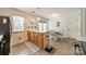 Kitchen featuring oak cabinets, laminate floors and sliding glass doors leading to outdoor space at 11515 Retriever Way, Charlotte, NC 28269