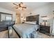 Comfortable main bedroom featuring a ceiling fan, wood-look flooring, and plenty of natural light at 11515 Retriever Way, Charlotte, NC 28269