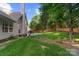Backyard features a stamped concrete patio, outdoor seating, and a well-maintained lawn at 12013 Regent Ridge Ln, Charlotte, NC 28278