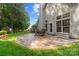 Backyard features a stamped concrete patio, outdoor seating, and views of the landscaped yard at 12013 Regent Ridge Ln, Charlotte, NC 28278