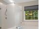 Bright bathroom with a tub and a window that provides natural light at 12013 Regent Ridge Ln, Charlotte, NC 28278