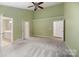 Large bedroom with open doors to the bathroom and closet at 12013 Regent Ridge Ln, Charlotte, NC 28278
