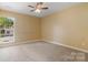 Bright bedroom featuring a ceiling fan and a large window letting in natural light at 12013 Regent Ridge Ln, Charlotte, NC 28278