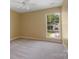 Bright bedroom featuring a ceiling fan and a large window letting in natural light at 12013 Regent Ridge Ln, Charlotte, NC 28278