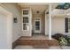 Inviting front porch with brick base and sidelight windows, offering a warm welcome at 12013 Regent Ridge Ln, Charlotte, NC 28278