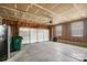 Unfinished garage with concrete floors and walls with a large door and two windows at 12013 Regent Ridge Ln, Charlotte, NC 28278
