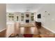 Bright living room featuring hardwood floors, fireplace, and abundant natural light at 12013 Regent Ridge Ln, Charlotte, NC 28278