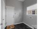 Mud room with grey walls, black tiled floor, and white door at 12013 Regent Ridge Ln, Charlotte, NC 28278