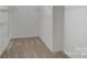 Walk-in Closet with white wire rack shelving and beige carpet at 12013 Regent Ridge Ln, Charlotte, NC 28278