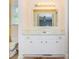 Bathroom vanity with white cabinets, gold hardware, and a large vanity mirror at 1211 Starlight Dr, Shelby, NC 28152