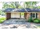 View of the covered carport featuring brick lattice walls and a storage room with a white door at 1211 Starlight Dr, Shelby, NC 28152