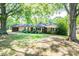 Beautiful one-story brick home with lush green lawn and mature trees providing shade at 1211 Starlight Dr, Shelby, NC 28152