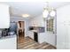 Traditional kitchen with white cabinets, wood-look flooring, and black appliances at 1211 Starlight Dr, Shelby, NC 28152