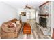 Inviting living room with a stone fireplace, ceiling fan and wood-look laminate flooring at 1211 Starlight Dr, Shelby, NC 28152