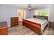 Spacious main bedroom with ceiling fan, dresser, and wood-look laminate flooring at 1211 Starlight Dr, Shelby, NC 28152