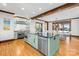 Bright open-concept kitchen and dining area with island, modern appliances, and wooden beam accents at 12613 Oak Grove Rd, Stanfield, NC 28163