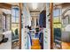 Well-organized walk-in closet with custom shelves, drawers, and mirrored doors for functional storage at 12613 Oak Grove Rd, Stanfield, NC 28163