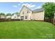 View of backyard featuring a lawn, vinyl siding, screened in porch, and wooden fence at 13032 Windy Lea Ln, Huntersville, NC 28078