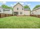 Back exterior view of home showcasing the fenced yard, screened in porch, and lawn at 13032 Windy Lea Ln, Huntersville, NC 28078