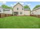 View of backyard featuring a lawn, vinyl siding, screened in porch, and wooden fence at 13032 Windy Lea Ln, Huntersville, NC 28078
