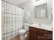 Bathroom with a shower featuring a white shower curtain, dark wood vanity, and an oval sink at 13032 Windy Lea Ln, Huntersville, NC 28078