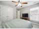 Bedroom with a ceiling fan, large window, bed, and closet with white doors at 13032 Windy Lea Ln, Huntersville, NC 28078