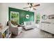 Bedroom featuring a white crib with a dark green accent wall, a dresser, and a side chair at 13032 Windy Lea Ln, Huntersville, NC 28078