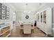 Formal dining area with a chandelier, complemented by neutral walls and elegant furnishings, creating a refined ambiance at 13032 Windy Lea Ln, Huntersville, NC 28078
