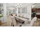 Elegant dining room with stylish chandelier, neutral tones, and seamless flow into other living spaces at 13032 Windy Lea Ln, Huntersville, NC 28078
