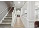 Inviting hallway with hardwood floors and staircase leading to the upper level, seamlessly connecting the home's spaces at 13032 Windy Lea Ln, Huntersville, NC 28078
