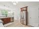 Modern kitchen with stainless steel refrigerator, dark wood cabinets, and tile backsplash at 13032 Windy Lea Ln, Huntersville, NC 28078