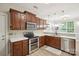 Well-equipped kitchen featuring stainless steel appliances, wood cabinets, and sleek countertops at 13032 Windy Lea Ln, Huntersville, NC 28078