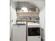 Functional laundry room featuring a washer, dryer, and stylish shelving for storage at 13032 Windy Lea Ln, Huntersville, NC 28078