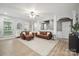 Open living room with stylish furnishings, wood floors, and ample natural light, perfect for relaxation and entertaining at 13032 Windy Lea Ln, Huntersville, NC 28078